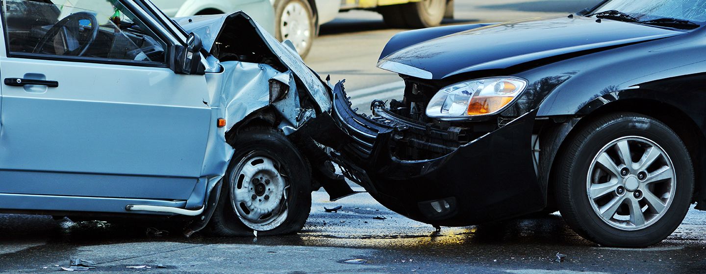 two sedans, crashed head-on with smashed front bumpers